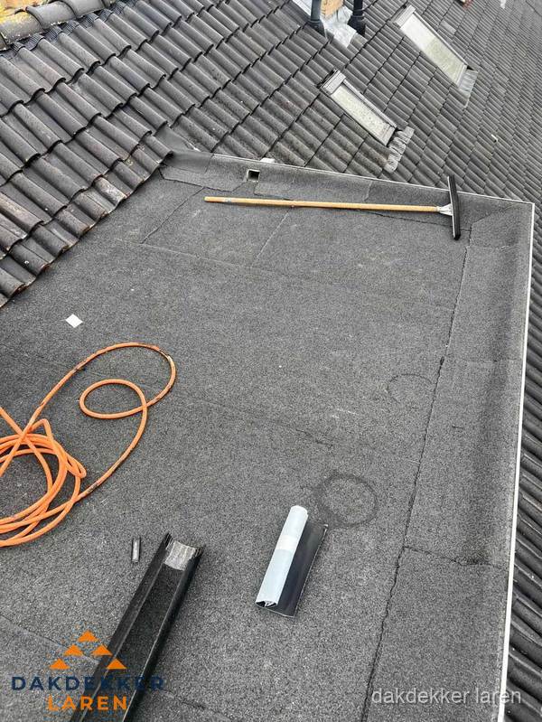 Plat dak reparatie met gereedschap en loodstroken in Laren Plat dak reparatie met gereedschap en loodstroken in Laren