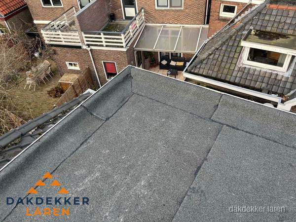 Overzicht plat dak met dakgoot in woonwijk Laren Overzicht plat dak met dakgoot in woonwijk Laren